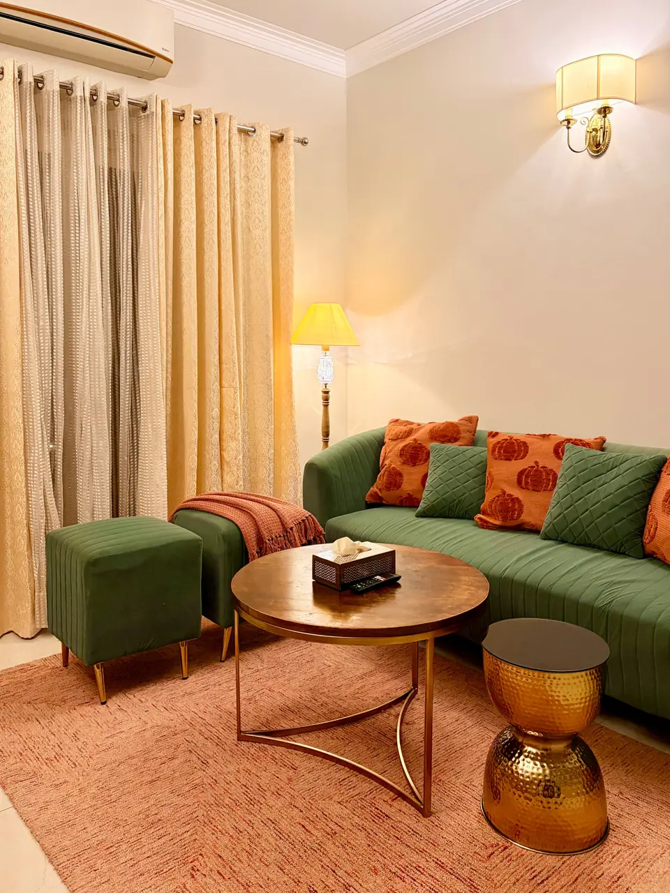 Sofa with orange cushions and floor lamp
