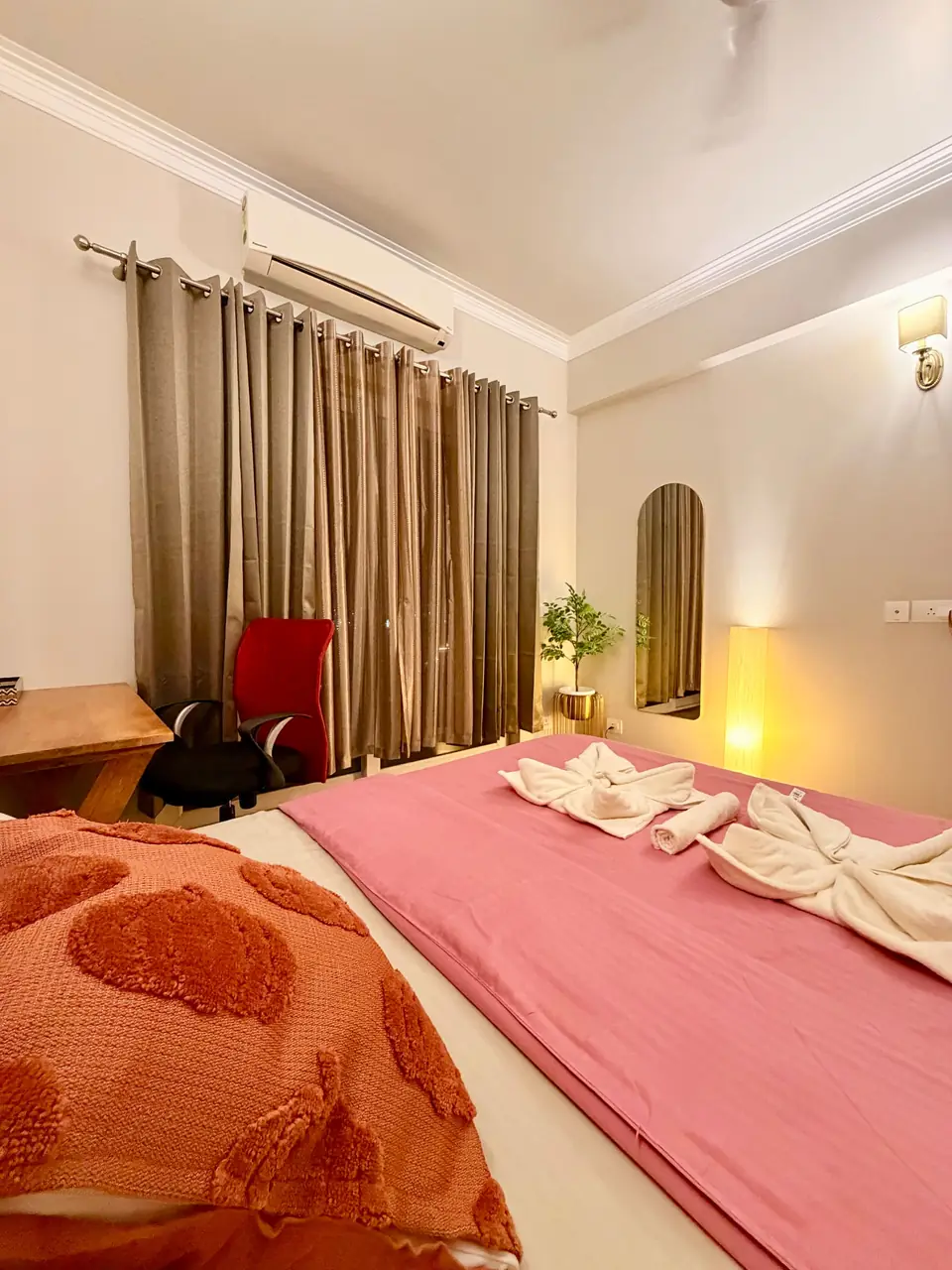 Bedroom with curtains and armchair
