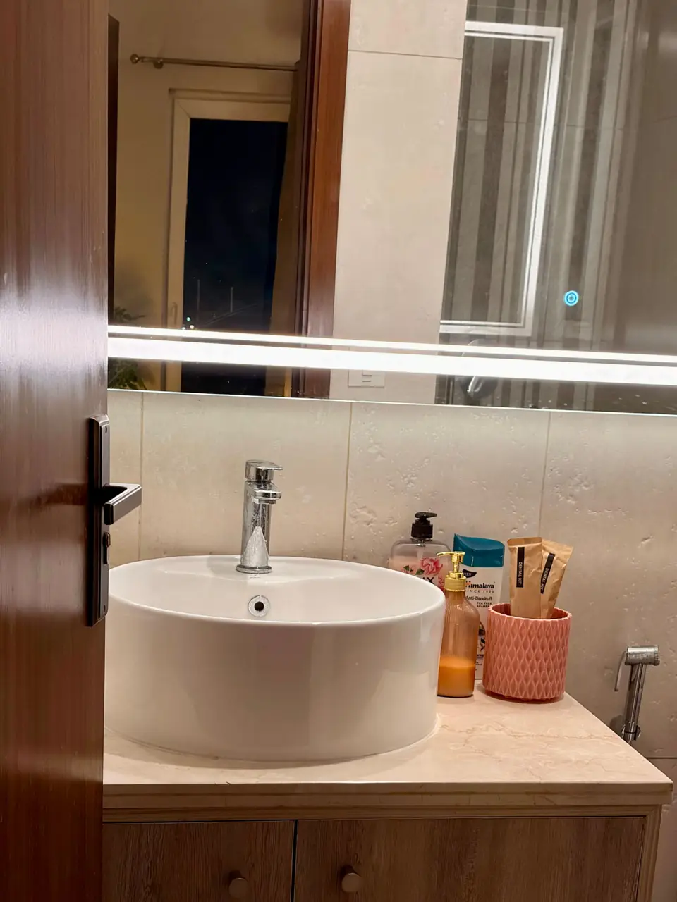 Bathroom with basin and lit mirror