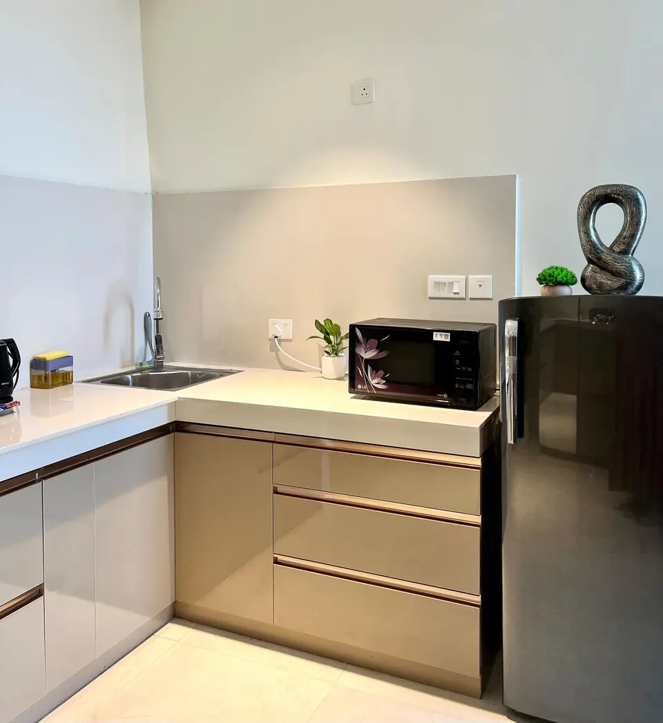 Kitchen counter with microwave and fridge
