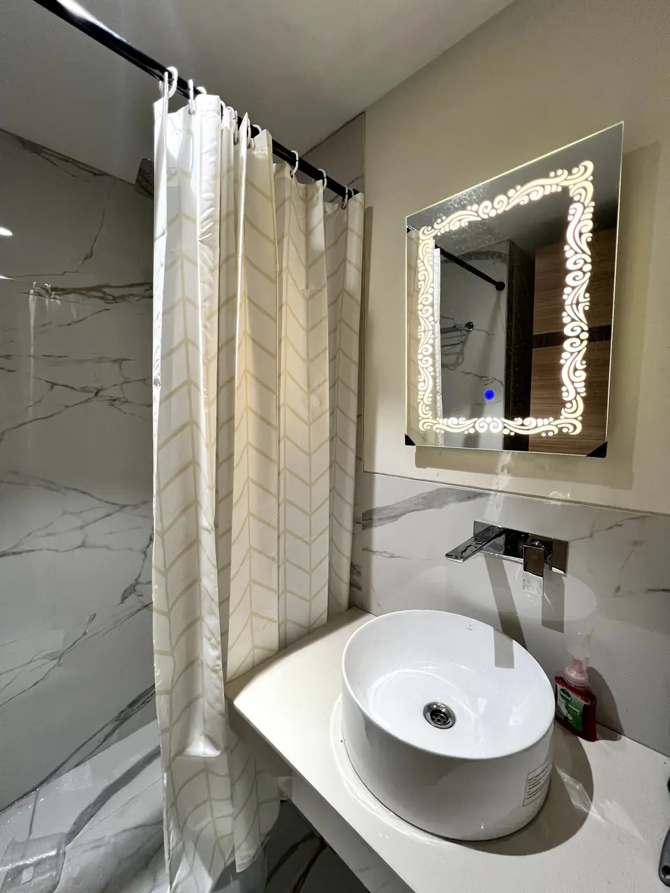 Bathroom with lit mirror