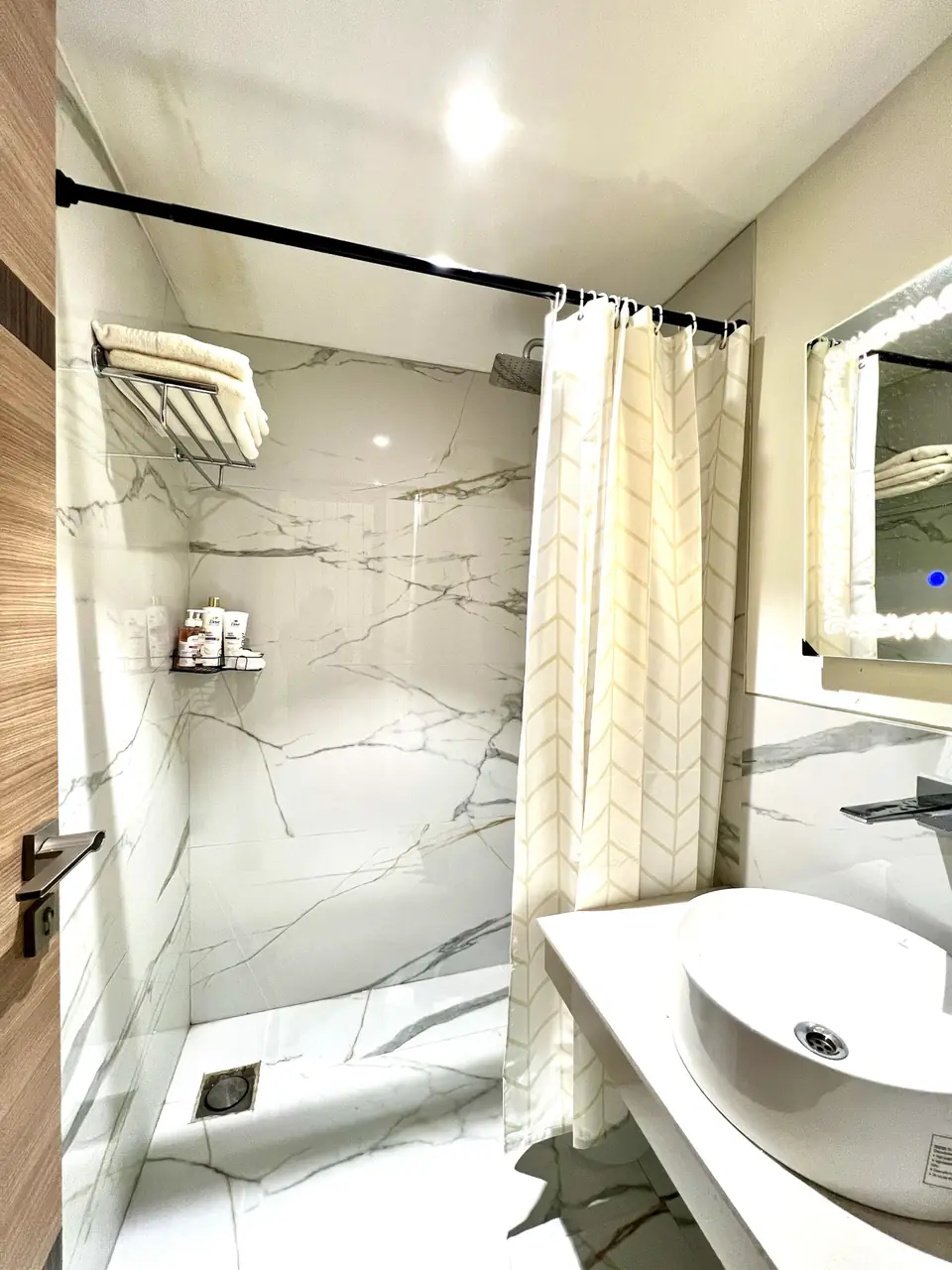 Shower area with marble tiles